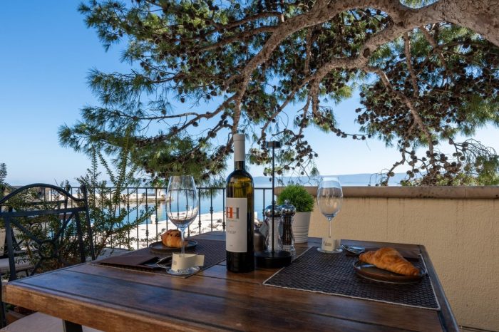 A beautiful arrangement with a bottle of wine on the outdoor terrace surrounded by greenery